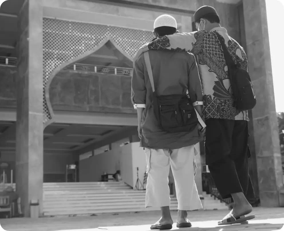 Two people looking at mosque entrance